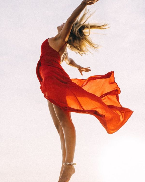 Woman feeling energetic and balanced in a bright, open space.